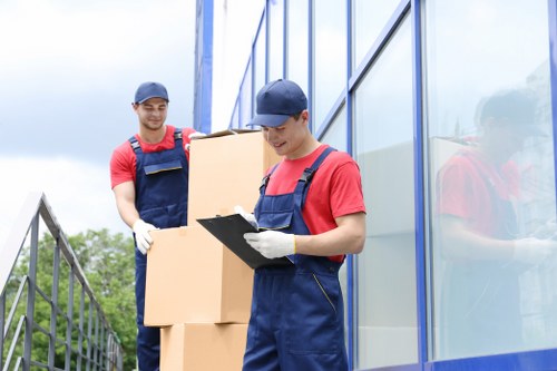 Careful unpacking of boxes in an Aldgate apartment
