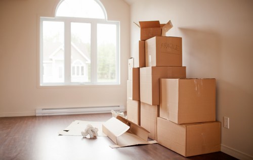 Household furniture and packed boxes ready for removal services in Aldgate