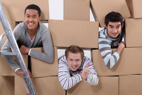 Packed boxes and moving items ready for collection by a removal van in Aldgate
