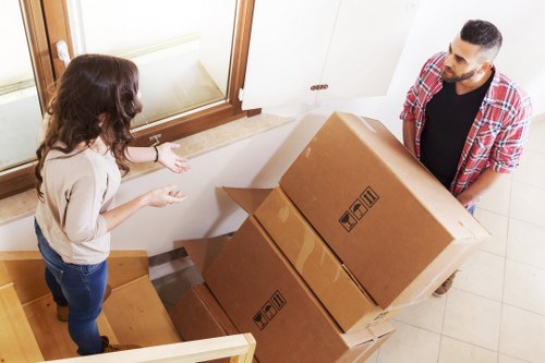 Professional movers loading boxes and furniture for a same day move